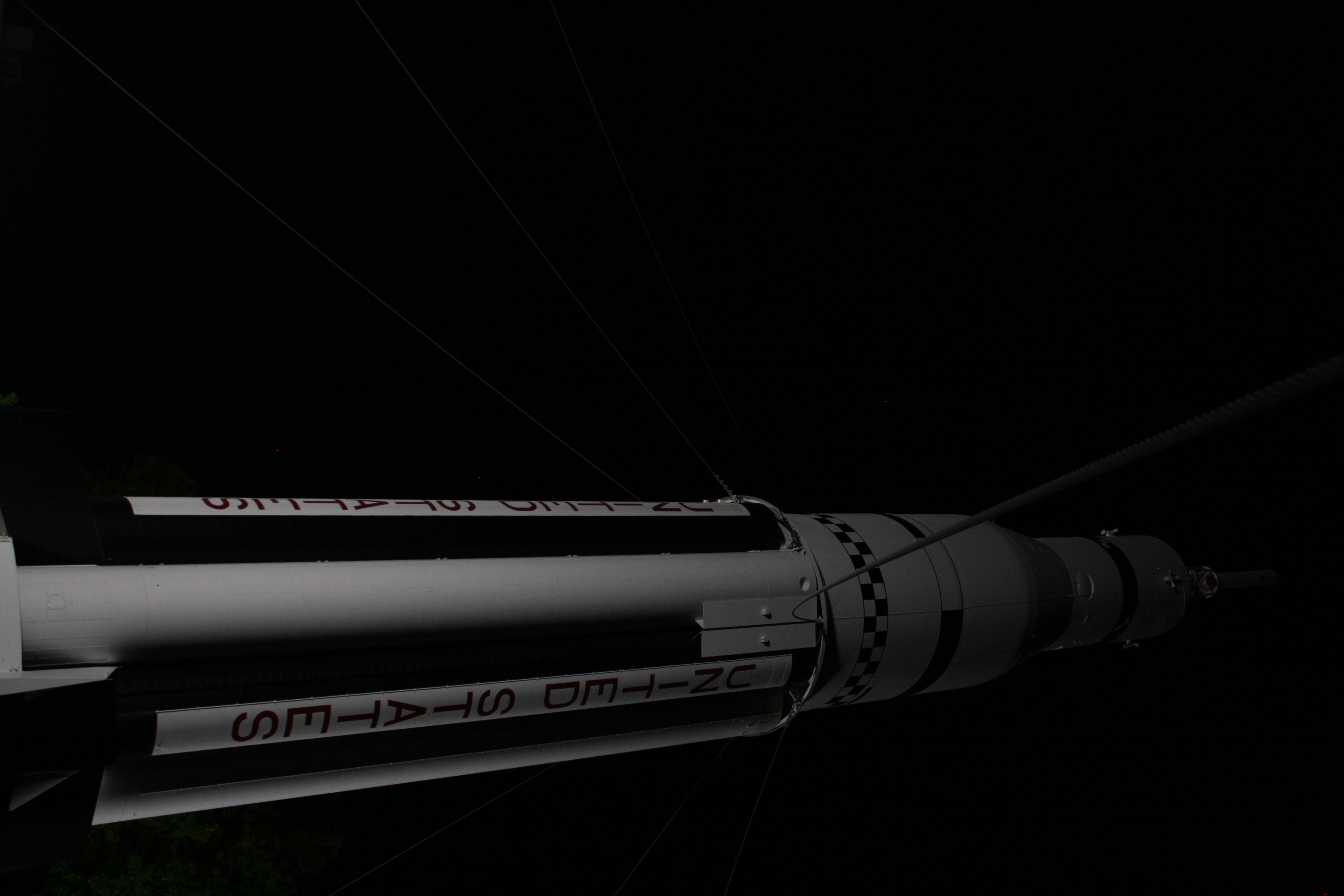 Rocket rising against a dark sky